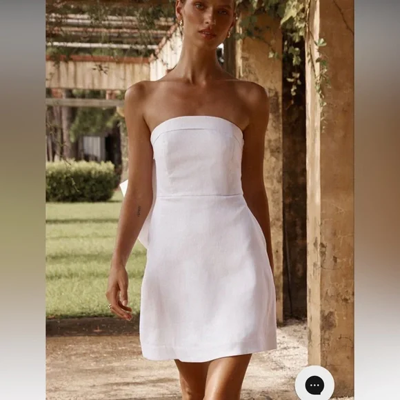 dissh aisle white linen back bow dress The Aisle linen bow mini dress Crafted in a luxurious yet effortless 100% linen, made to enhance and not overwhelm. Limited for pre-order online. #DISSH #TheAisleEdit
